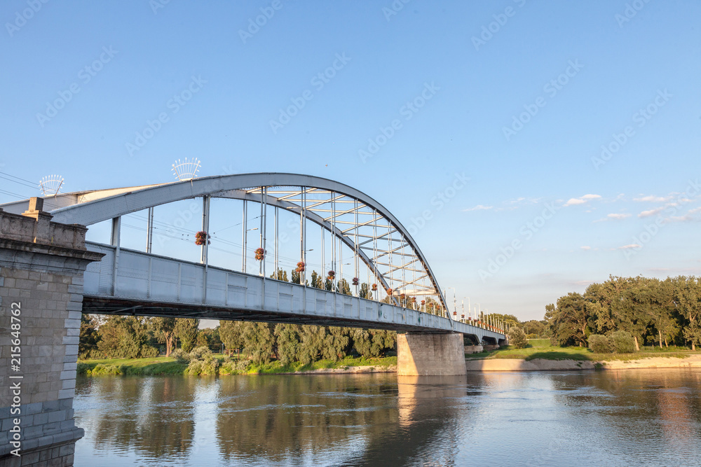Belvarosi Hid bridge, also known as Downtown bridge on the tisza river during a sunny afternoon. The bridge connects the two parts of this city, the main one of Southern Hungary