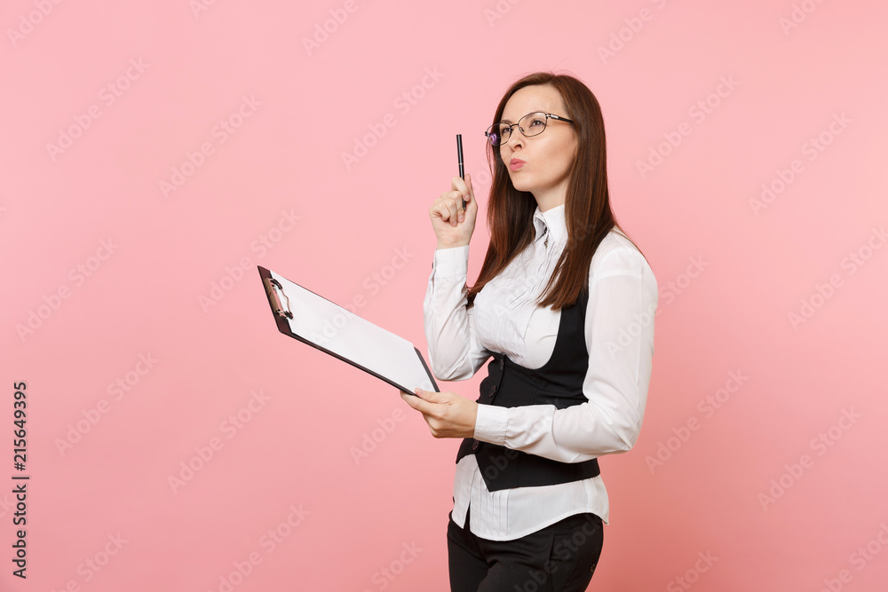 Young puzzled beautiful business woman in glasses holding clipboard tablet with papers document isolated on pink background. Lady boss. Achievement career wealth concept. Copy space for advertisement. Young puzzled beautiful business woman in glasses holding clipboard tablet with papers document isolated on pink background. Lady boss. Achievement career wealth concept. Copy space for advertisement.