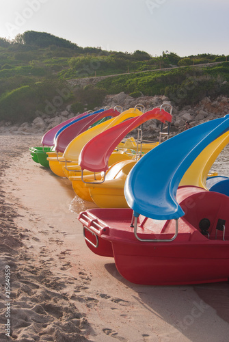 Line of six colorful pedal boat with slide