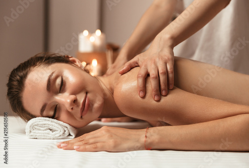 Serene young woman having massage