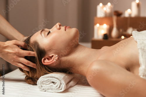 Beautiful young girl having face massage photo