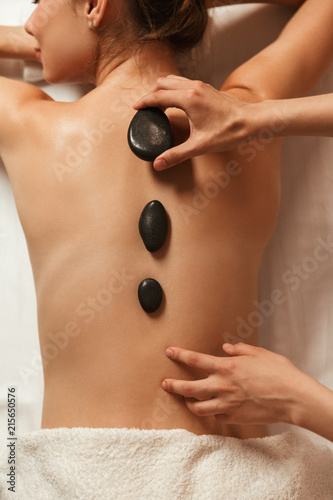 Top view of a woman having hot stone massage