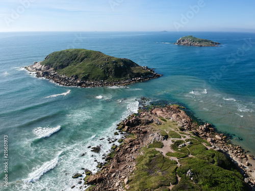  Aerial view of green islands on Brazilian beach with white sand and blue sea.