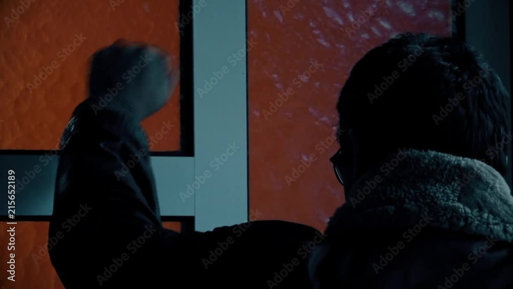 Man Holding a Gun in his Hand and Knocked on the Door Man Holding a Gun in his Hand and Knocked on the Door