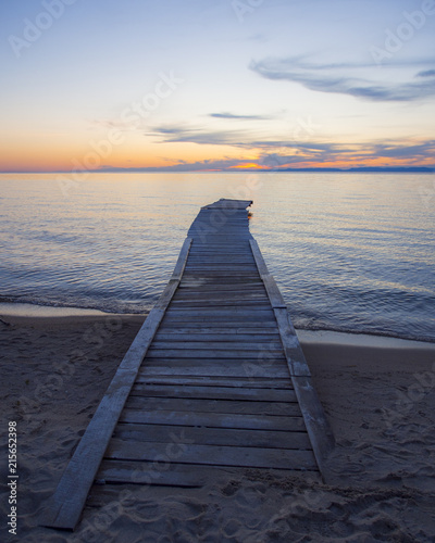 wooden pier on Baikal Lake at sunset