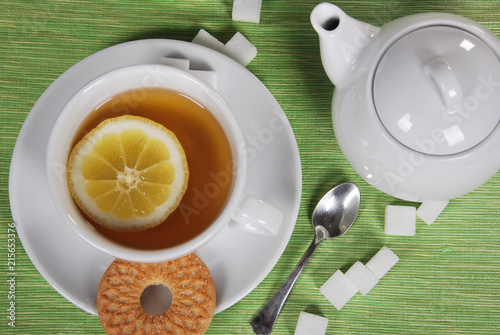 various cookies and biscuits baked at home in a container and tea in a retro cup with free space for text