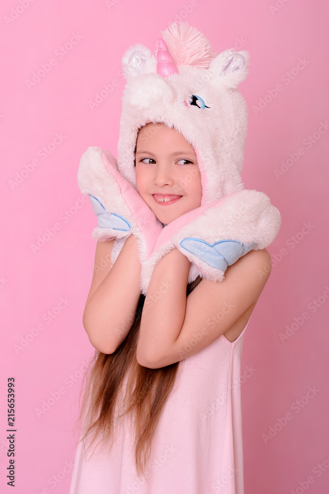 Caucasian beautiful little girl in a hat with unikorn Caucasian beautiful little girl in a hat with unikorn