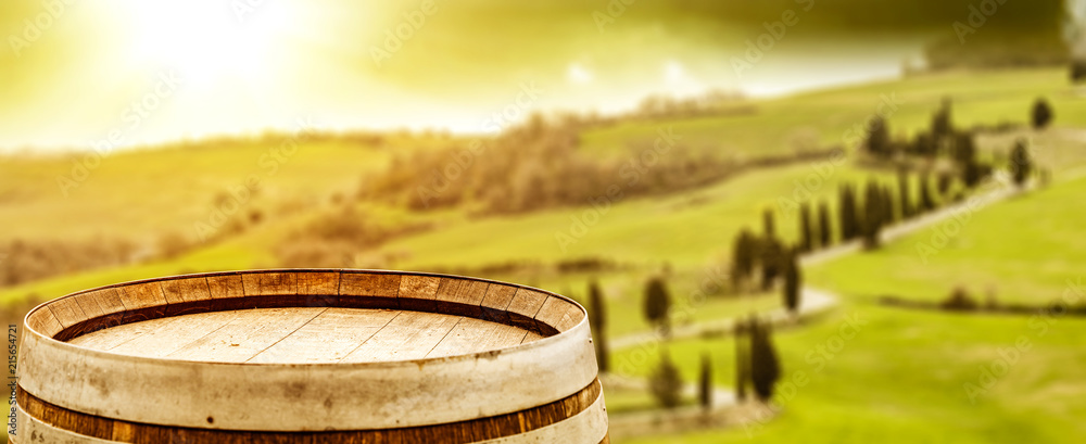 Wine photo of barrel and Tuscany landscape 