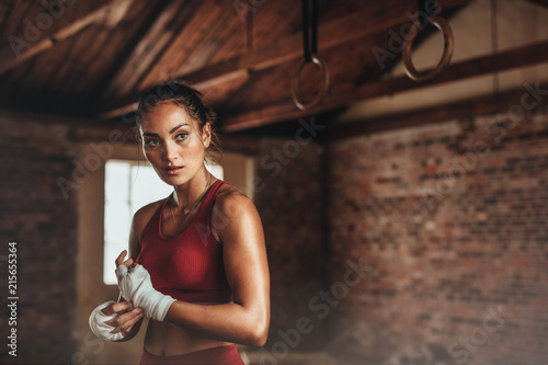 Female in shed preparing for boxing