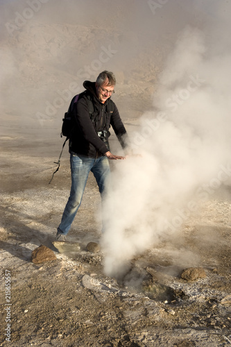 Man and a geyser, Atacama desert, Chile