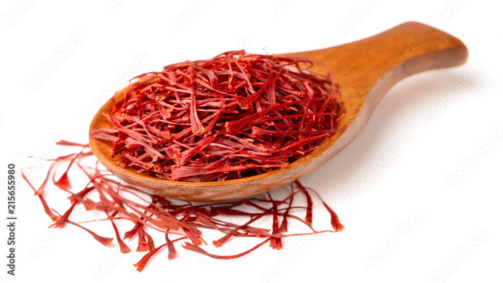 Fototapeta premium saffron thread in the wooden spoon, isolated on the white background.