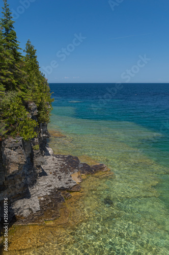 Lake Huron shoreline blue green water and limestone rocks along the Georgian bay lake shore landscape