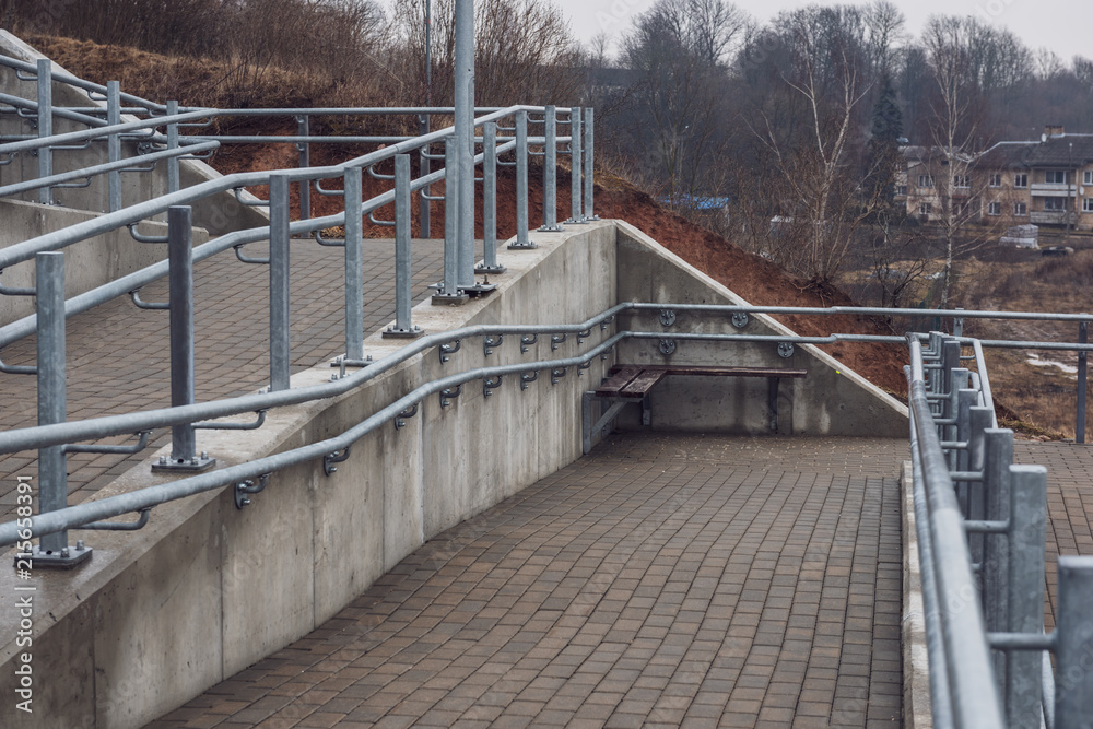brand new metal bridge with shiny rails and  concrete steps