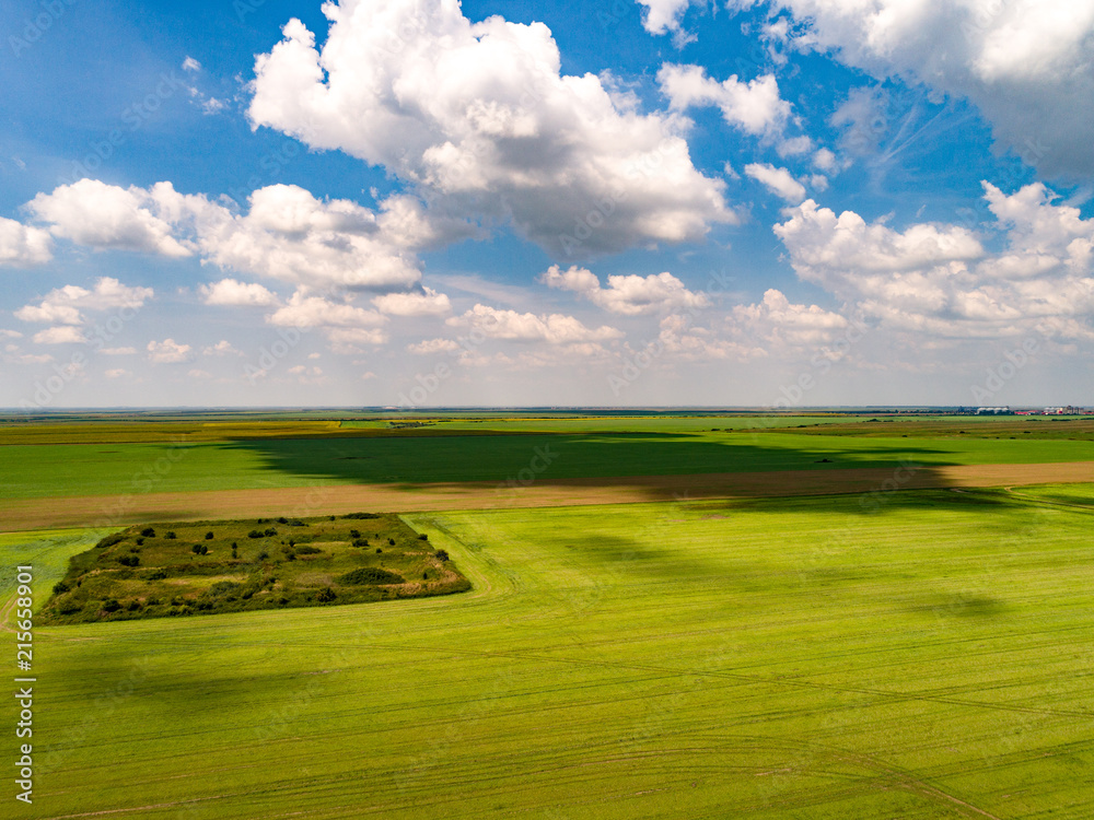 Aerial shot of beautiful agriculture fields with blue skies and fluffy  clouds in summer. Cloud shadow on the ground Photos | Adobe Stock