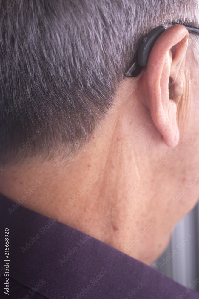Naklejka premium Deaf man hearing aid ear