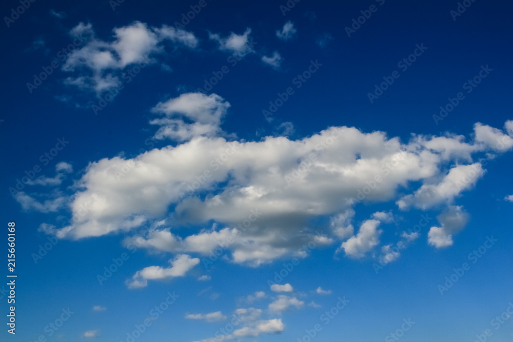 Obraz premium blue sky and heavy, white clouds