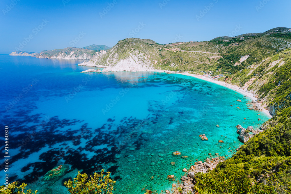 Myrtos beach with azure blue sea water in the bay. Favorite tourist visiting destination place at summer on Kefalonia island, Greece, Europe
