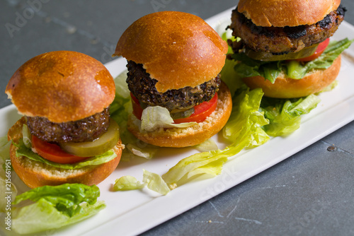 Close up shot of 3 sliders on a plate