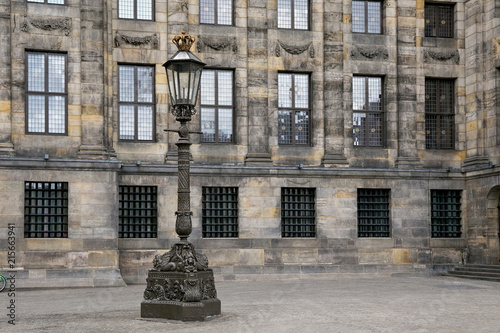 Streetlight near the Royal Palace of Amsterdam on the Dam Square. The palace was built as a city hall during the Dutch Golden Age in the 17th century. photo
