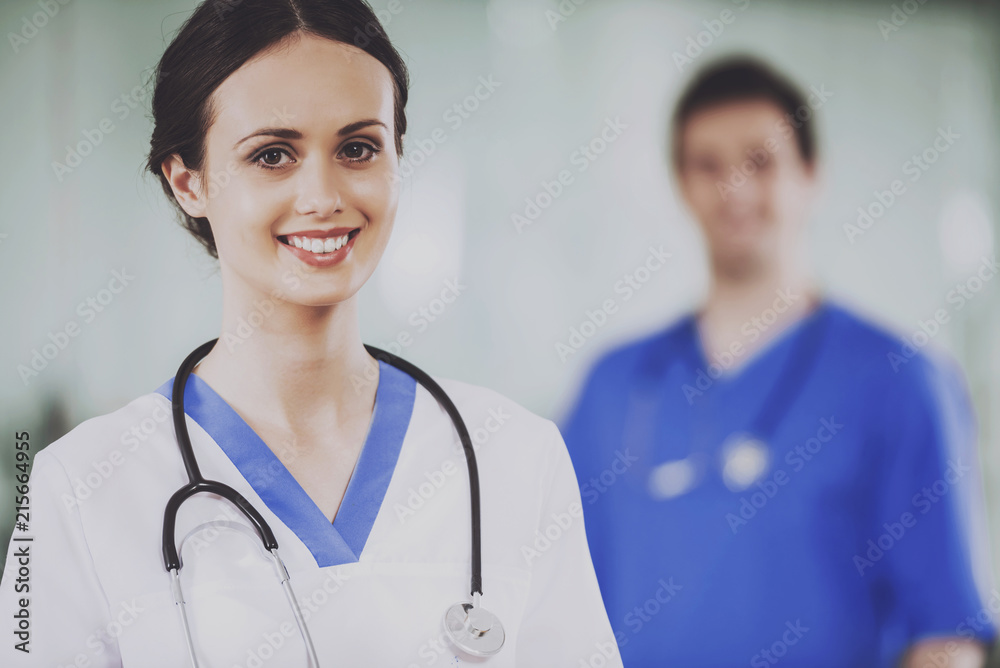 Female Doctor with Stethoscope in White Uniform. Female Doctor with Stethoscope in White Uniform.