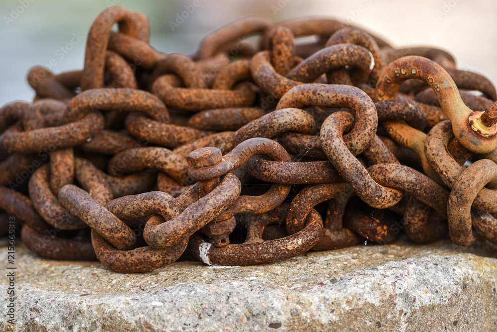 Old and rusty harbor chains.