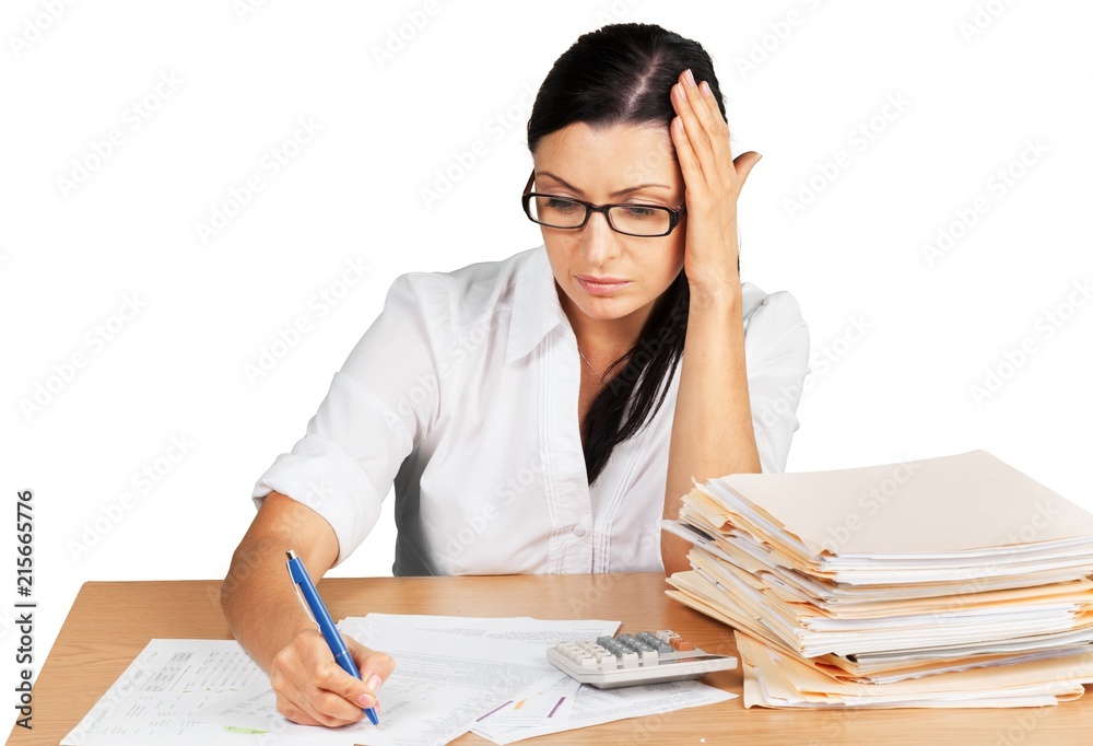 Businesswoman sitting at the table with many papers on Businesswoman sitting at the table with many papers on