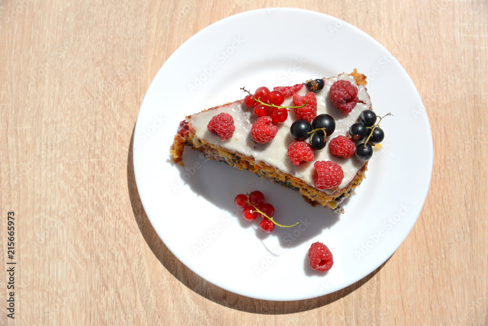 a cake with raspberry, black currant and red currant on a white a cake with raspberry, black currant and red currant on a white
