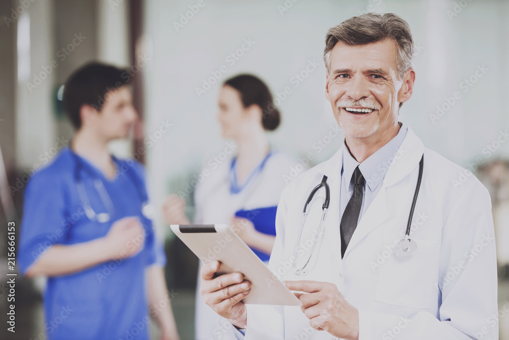 Male Doctor with Stethoscope in White Uniform. Male Doctor with Stethoscope in White Uniform.