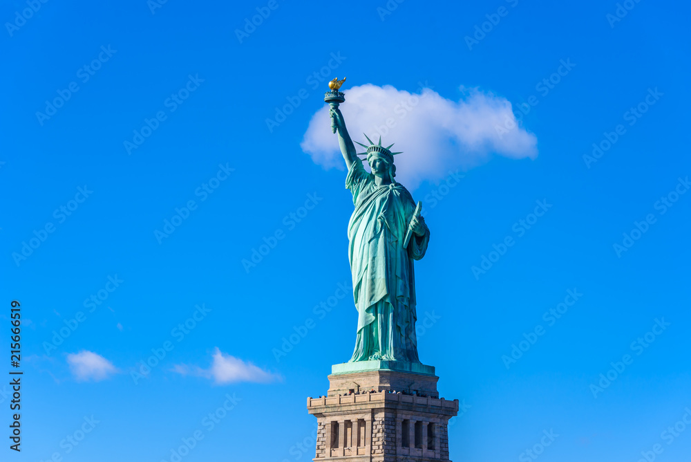 Fototapeta premium The statue of Liberty at a sunny day with blue sky, New York City, USA