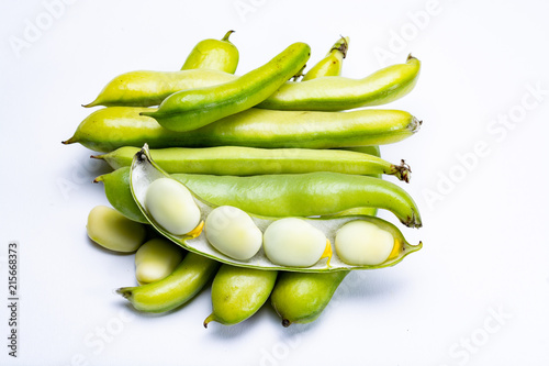 New harvest of healthy vegetables, green fresh raw big broad beans close up isolated on white background