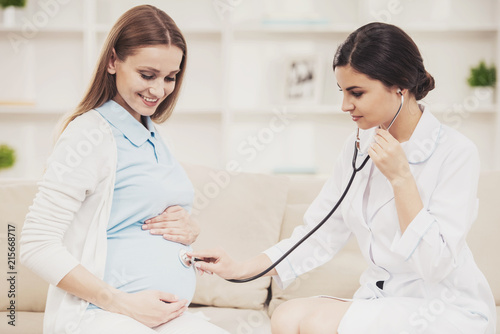 Pregnant Young Girl with Gynecologist in Hospital. photo