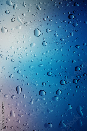 Water drops background.View through the window of strong rainy day  Shallow depth of field composition and color toned.