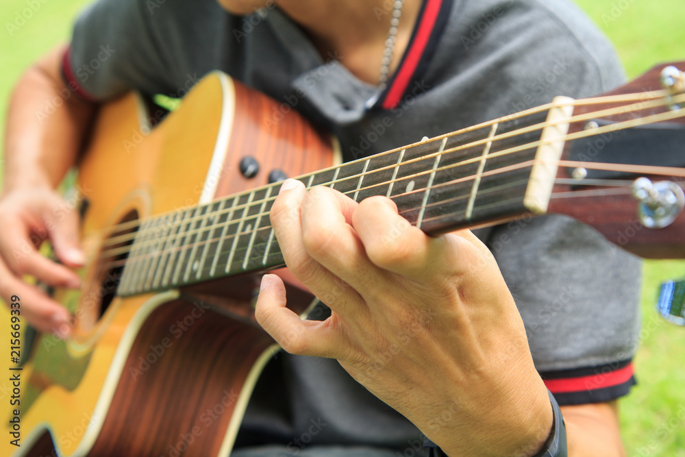 Musician playing guitar in the park Musician playing guitar in the park