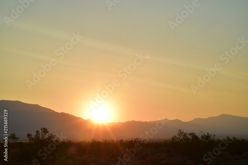 long exposure photos of the sun rising over the ridge of the Spring Mountains in the Mojave Desert town of Pahrump, Nevada, USA