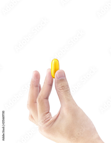 Fish oil capsule in hold hand isolated on white background