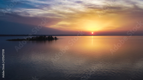 Beautiful pink sunset with sun rays over sea.