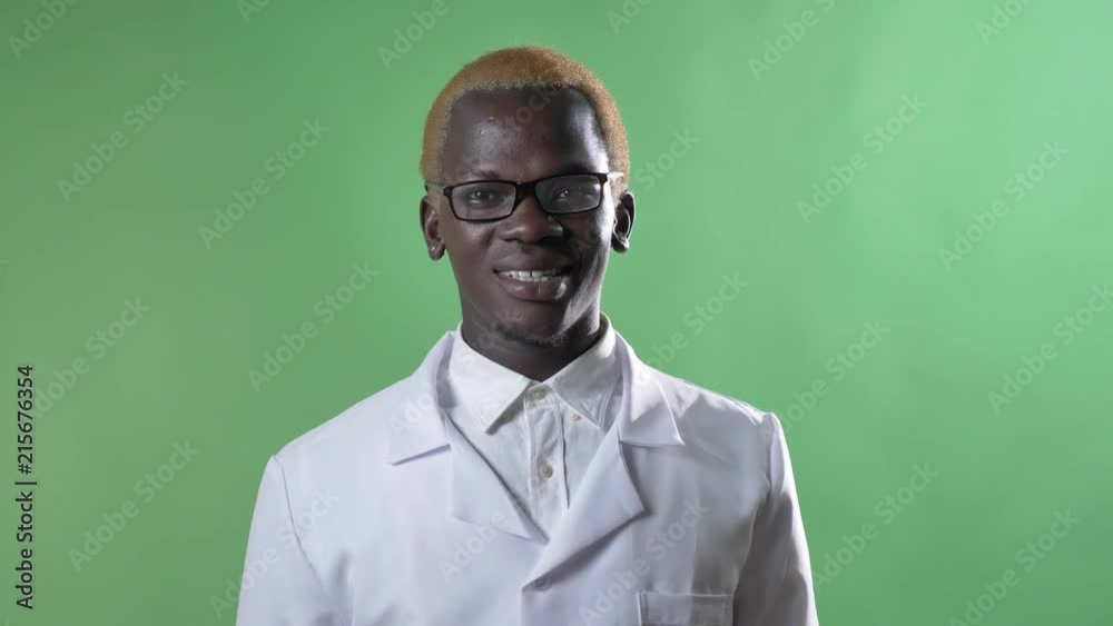 Young african american blond doctor in glasses smiling at camera, isolated on chroma key background Young african american blond doctor in glasses smiling at camera, isolated on chroma key background