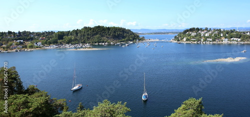 Oslo, Norway - July 22, 2018: View to Oslo Fjord. Two islands Ormoya and Malmoya connected to the mainland by bridge, just east of the city center. photo