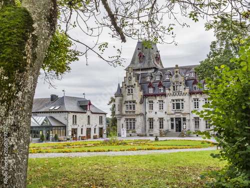 Castle of Petite Somme, Radhadesh as seen from the street against a September overcast sky, at Septon-Durbuy, Belgium photo