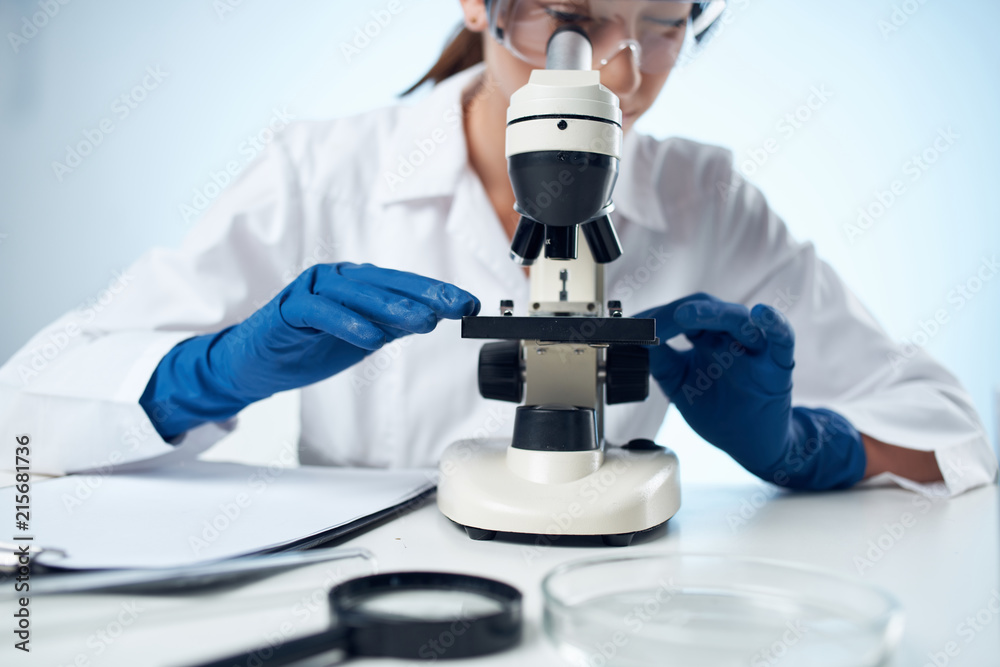 scientist looking at microscope scientist looking at microscope