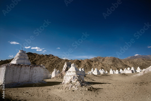 White ancient Buddhist chortens (stupas) in valley near Leh, Ladakh, India.