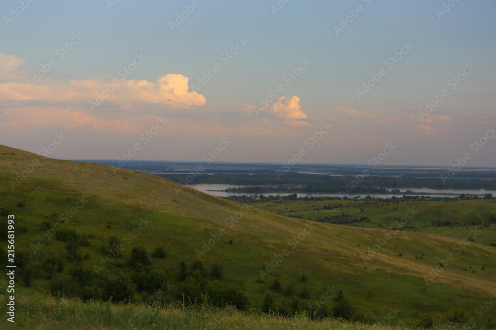 Panorama of a beautiful hill landscape, lake, river, forest, trees, and sky Russia. Life in the village