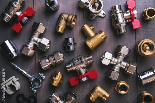group of plumbing fittings and equipment on wooden background photo