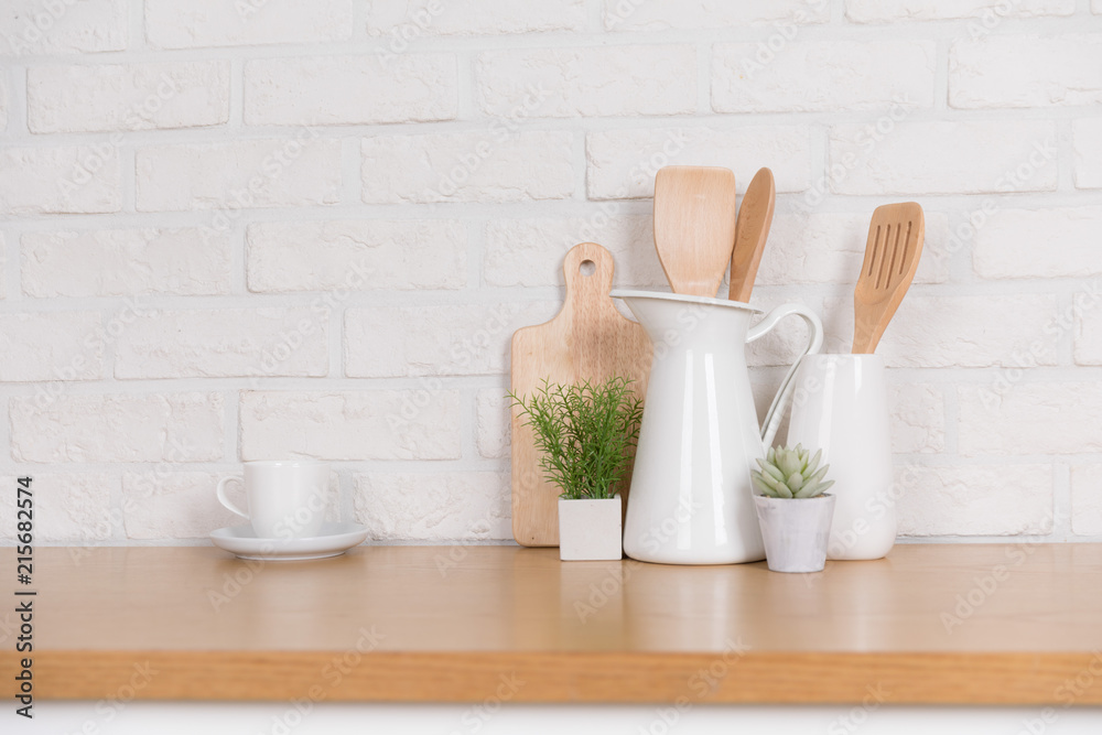 Kitchen utensils and dishware on wooden shelf. Kitchen interior background Kitchen utensils and dishware on wooden shelf. Kitchen interior background