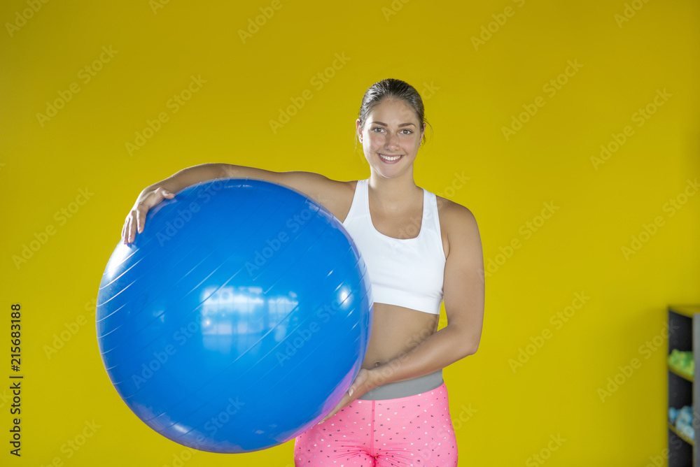 Woman at the gym with a pilates ball