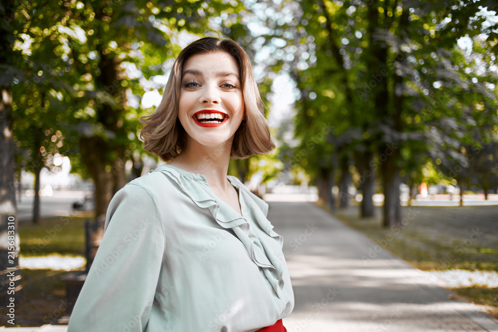 woman smiling in summer park woman smiling in summer park