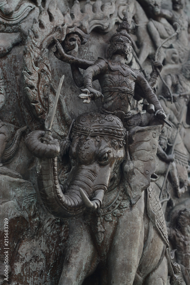 The demon army over Elephant Thai style Teak wood carving at Wat Traimitr (Thai Temple) Bangkok,Thailand