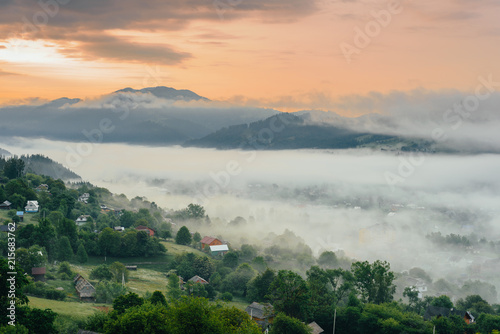 Morning fog on the slopes of the Carpathian Mountains . summer mountains rural landscape.