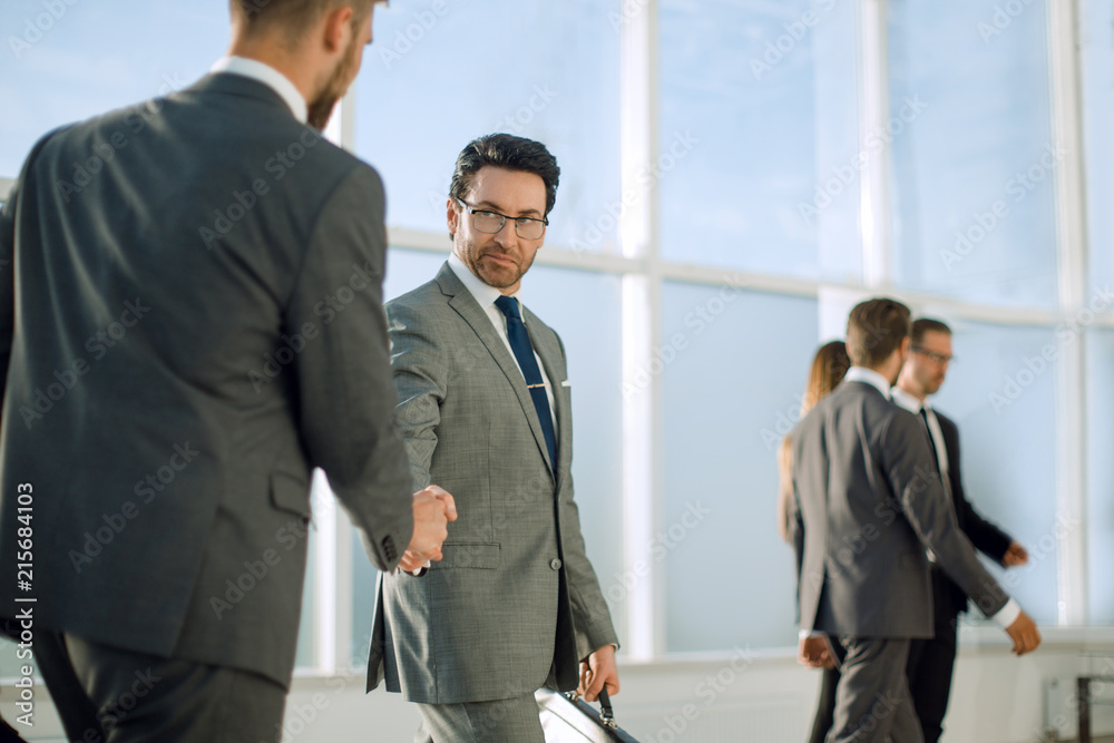 Fototapeta premium businessmen handshaking after striking deal