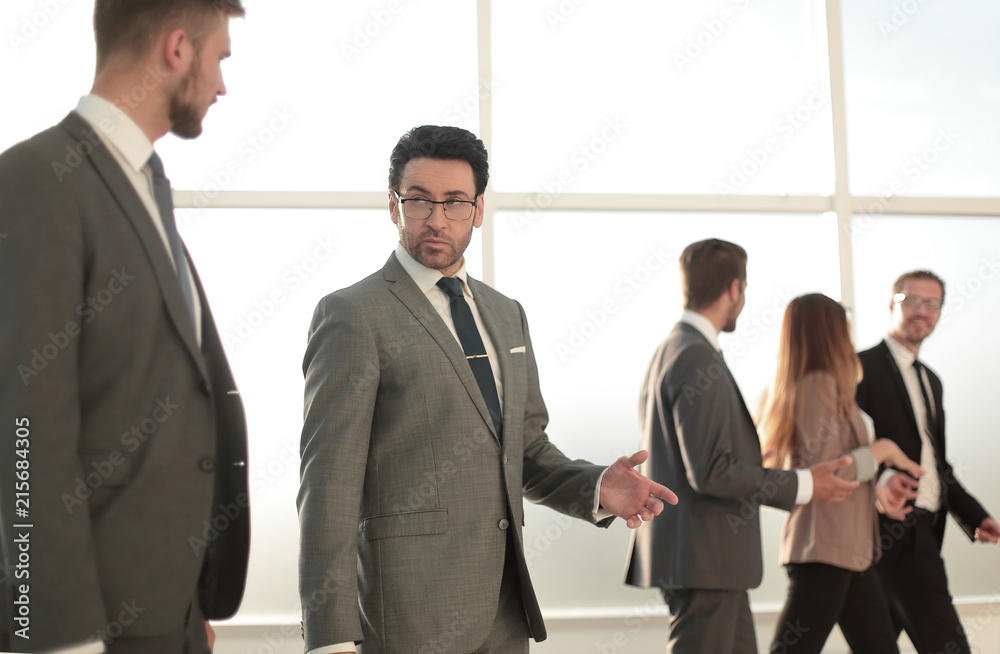 Two businesspeople walking in corridor talking Two businesspeople walking in corridor talking